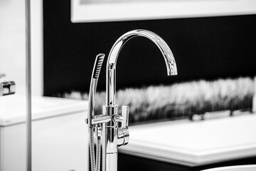 A steel water tap stands in the bathroom

