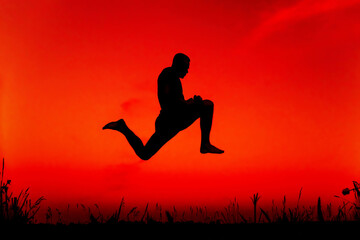 Fototapeta na wymiar silhouette of a sporty man jumping high in nature