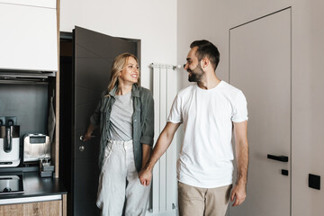 Loving couple standing together indoors at home