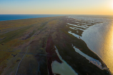 aerial view of autumn steppe on the island at sunset, aerial view of Dzharylgach island in autumn,...