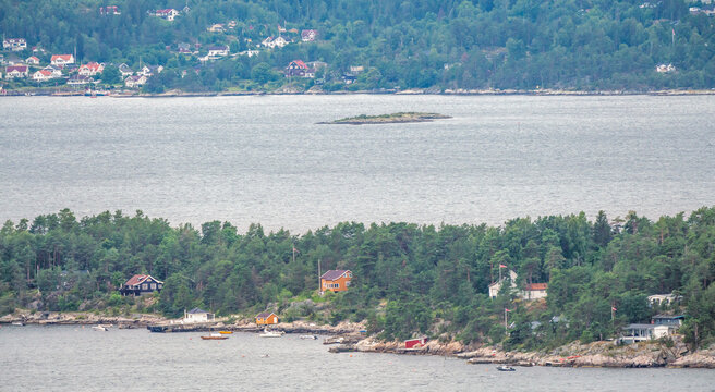 View over island just outside Nesodden, Oslo, Norway. Boats and cabins during summer vacation.