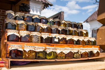 colorful russian glass jam jars on the wooden stand. Russia, Tatarstan, Kazan, Sviyazhsk
