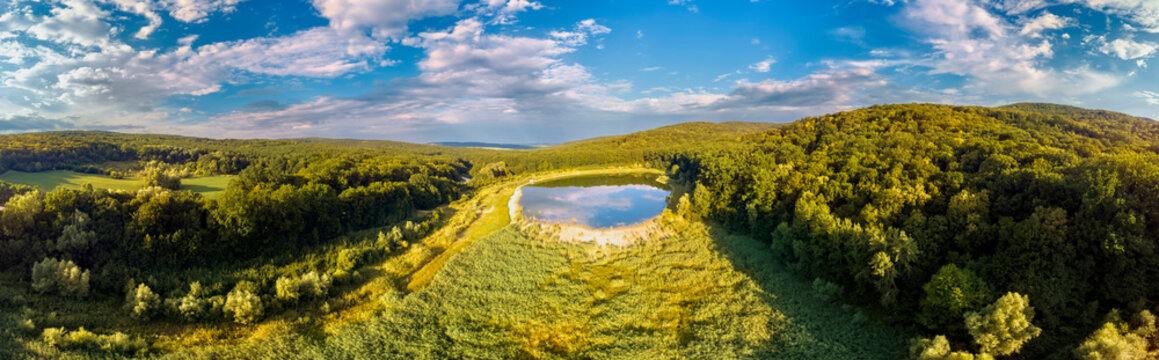 Lake and trees in green forest of Moldova