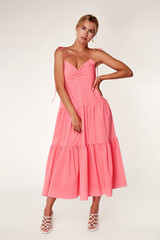 Beautiful woman fashion model makeup brunette hair perfect body shape tanned skin wear clothes summer collection organic long pink silk dress stylish sandals shoes, accessory jewelry earrings date.