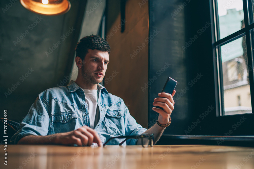 Poster confused hipster guy reading email with bad news from colleague using application for chatting on sm