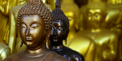 close up of head of statue of buddha, in buddhist temple ,with golden color