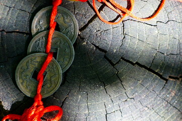 Metal Feng Shui coin on a wooden background.