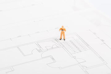 Building renovation drawings and miniature workers
