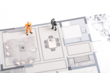 Building renovation drawings and miniature workers
