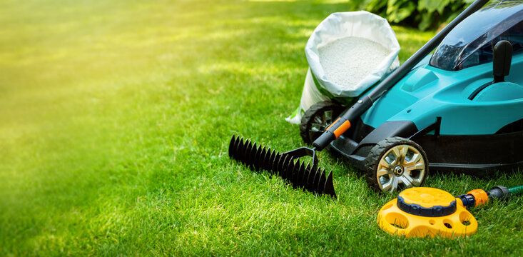 garden lawn care tools and equipment for perfect green grass. banner copy space