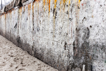 Background concrete wall, traces of weathering, worn wall damaged paint old paint. Remains of old paint on the painted concrete surface. Grungy concrete surface. Perspective