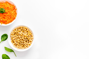 Vegetarian bowl with chickpeas and vegetables - white table top view copy space