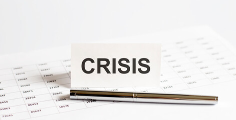 Text CRISIS on stickers,pen on the background of documents. Financial bookkeeping, Accounting Concept. Top view.