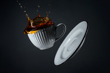 levitating cup with splash. Floating dishes. Cafeteria concept. Minimal art trend.