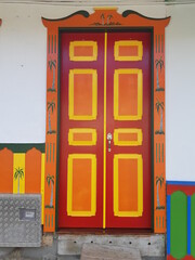 Unique colonial style house colorful doors at city centre of Salento. Colombia.