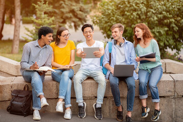 Multiracial students studying together in the park