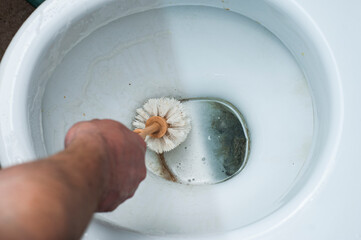 The result of using different methods of cleaning the toilet bowl in one photo, using chemistry and...