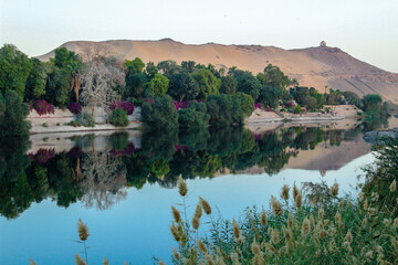 Fototapeta na wymiar Elephantine Island on the bank of Nile river with the blue sky and plants in Aswan, Egypt.