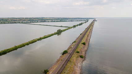 Fototapeta na wymiar Aerial view from flying drone of Fish pond near railway. Fish farm