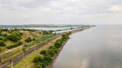 Fototapeta na wymiar Aerial view of train railway over the river in Ukraine Top view of railroad from drone.