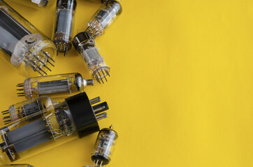 Random vacuum tubes on a yellow background.