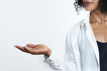 hand of an afro-american woman displaying something on a white copy space