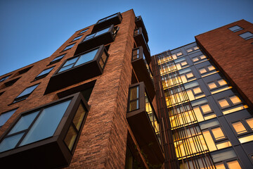 Exterior of a modern multi-storey residential building made of bricks in a Scandinavian style in Copenhagen, Denmark