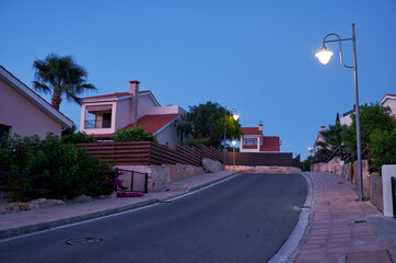 Fototapeta na wymiar The view of the street of Pissouri village in the evening light. Limassol district. Cyprus