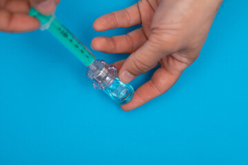 Close-up medical syringe with a vaccine concept.