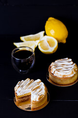 Composition with tasty lemon meringue pie on dark table .