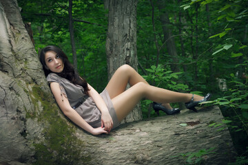 Outdoors portrait of beautiful young woman in the forest.