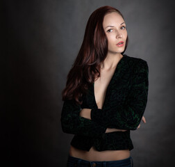Portrait of beautiful sensual woman in green a jacket, close-up. Studio shot.