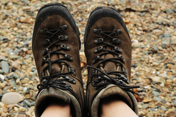 Leather trekking old boots on the seaside