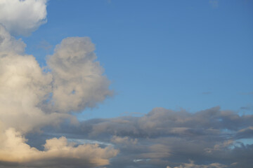Sunset gray and yellow clouds in the evening blue sky