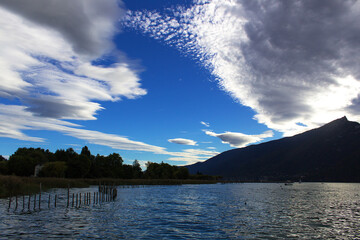 Beautiful summer scenic sunset on lake Bourget alps mountain coast with dark contract colors and...