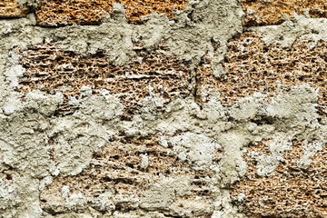 Abstract background of the old wall of black natural stone with cracks and scratches. Landscape style. Great background or texture.