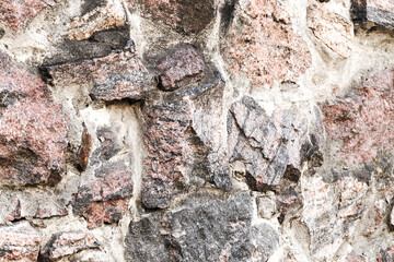 Abstract background of the old wall of black natural stone with cracks and scratches. Landscape style. Great background or texture.