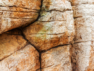 Abstract background of the old wall of black natural stone with cracks and scratches. Landscape...