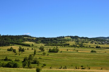 Fototapeta na wymiar Podhale, Poland. Beautiful landscape, panorama. Idyllic view with green hills, fields and meadows.