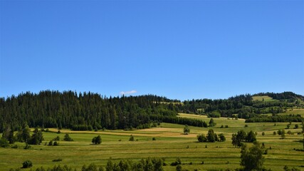 Fototapeta na wymiar Podhale, Poland. Beautiful landscape, panorama. Idyllic view with green hills and meadows.
