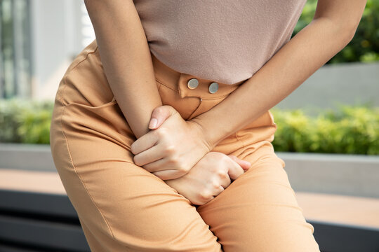 woman holding her pee, health care concept of urinary tract infection; urinary incontinence; overactive bladder symptoms