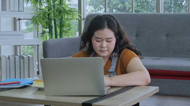 Fat Women Sit And Work At Home While Eating Sweets Happily. Work From Home Concept