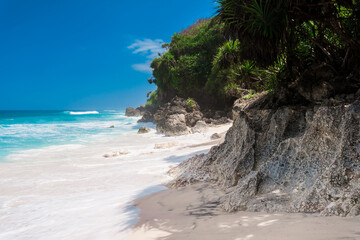 Tropical wild beach with white sand and turquoise sea with waves