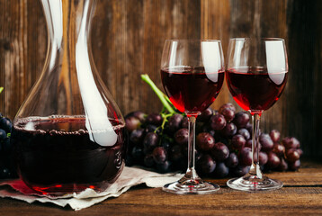 Two glasses of red wine and a decanter