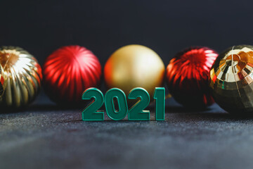 Composition with numbers 2021 and Christmas tree decorations balls. Holiday and new year concept.