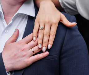 young people with twisted hands on which wedding engagement rings in white gold with diamonds. wedding ceremony marriage