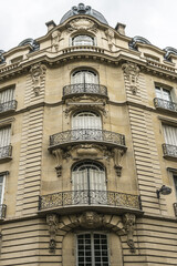 Old French house with traditional balconies and windows. Paris, France.
