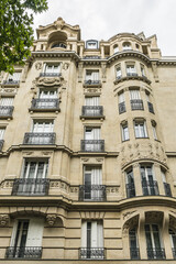 Old French house with traditional balconies and windows. Paris, France.
