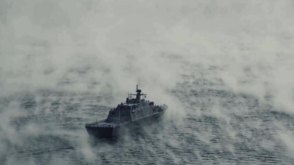 Drone shot of navy ship on foggy sea, rear