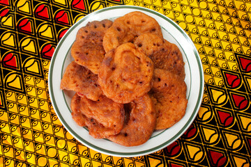 A Plate of Delicious Homemade Bean Pancakes or Nigerian Flat Akara placed on a colorful yellow...
